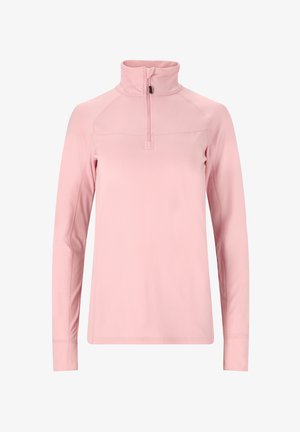 Camicia a maniche lunghe di un tenue rosa pallido con colletto alto e chiusura a mezza zip, realizzata in tessuto morbido e liscio. Cuciture piatte e design aderente.