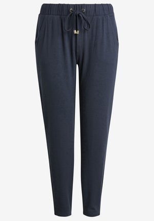 Navy jogger-housut, jotka on valmistettu pehmeästä kankaasta. Sarjaan kuuluu joustava vyötärönyöri, kaksi sivutaskua ja kapenevat lahkeet.