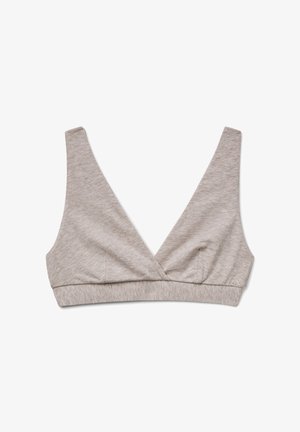 Hellbeige weiche Stoff-Bralette mit tiefem V-Ausschnitt, breiten Trägern und einem elastischen Unterband für Unterstützung, auf einem weißen Hintergrund präsentiert.