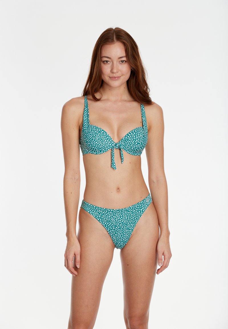 Tirkīza krāsas bikini komplekts ar baltām punktiņām; ar mīkstu krūšu daļu un regulējamiem siksnām; atbilstošas hipster biksītes ar vidēju aizsegu.