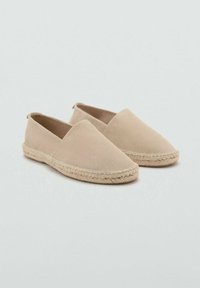 Beige slip-on espadrilles with a smooth suede upper and woven jute sole. Features a rounded toe and minimalistic design without fasteners.