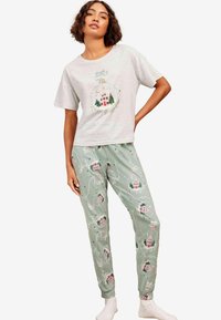 Šedý krátký rukáv pyžamového trika obsahuje vánoční ozdobu. Zelené kalhoty s vánočními vzory domů a stromů, elastický pas, měkká tkanina.