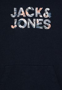 Sötétkék pulóver, nagy, több színű "JACK & JONES" felirattal, amelyen virágminták találhatók, és textúrált szövetfelülettel rendelkezik.