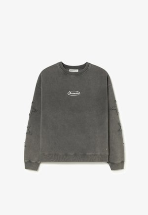 Sudadera gris oscuro con cuello redondo, con el logo "Brownie" en el pecho y parches de estrellas desgastadas en ambas mangas.