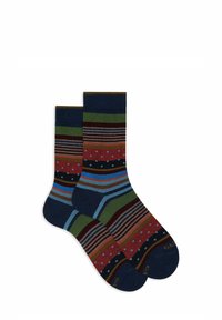 Calzini multicolori con righe audaci, pois e bande. I colori includono blu navy, rosso, verde e marrone con texture a contrasto.