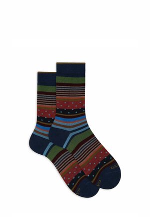 Calzini multicolori con righe audaci, pois e bande. I colori includono blu navy, rosso, verde e marrone con texture a contrasto.