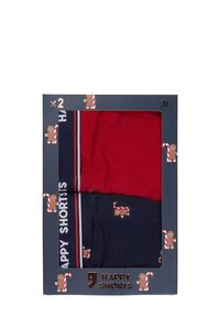Sada dvou bavlněných šortek v červené a námořnické barvě, zdobené vzory cukrové třtiny a perníkového mužíčka, s kontrastními pruhovanými pasy.