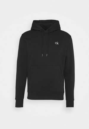 Musta kapuutsiga särk, millel on tasku, jooned ja väike valge "ck" logo rinnal. Valmistatud pehmest, tekstuuriga kangast.