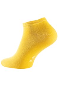 Calzino giallo alla caviglia con bordo a costine, texture liscia e indicazione della taglia stampata in bianco su un lato.