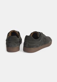 Dark gray suede sneakers with round toes, flat laces, and brown rubber outsoles; features stitched details and padded collars.