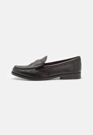 Black leather loafer shoe with textured surface, round toe, and decorative stitched detailing. Features a flat heel and slip-on design.