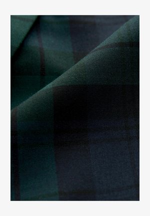 Tartan fabric in dark green and black, featuring a check pattern with a smooth, textured finish. Soft material with draped layers.