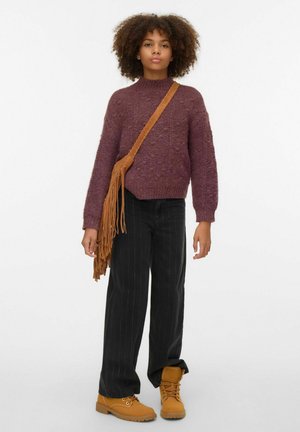 Purple knit sweater with a high neck, black striped wide-leg trousers, and tan lace-up boots. Brown fringed crossbody bag.