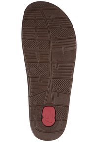 Sola in gomma marrone con diversi modelli di battistrada. Include un accento rosso e un logo circolare nella zona del tallone.