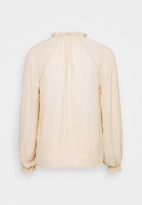 Ljus beige långärmad blus med volangkrage och samlade manschetter. Har ett texturerat tyg med en slät yta.