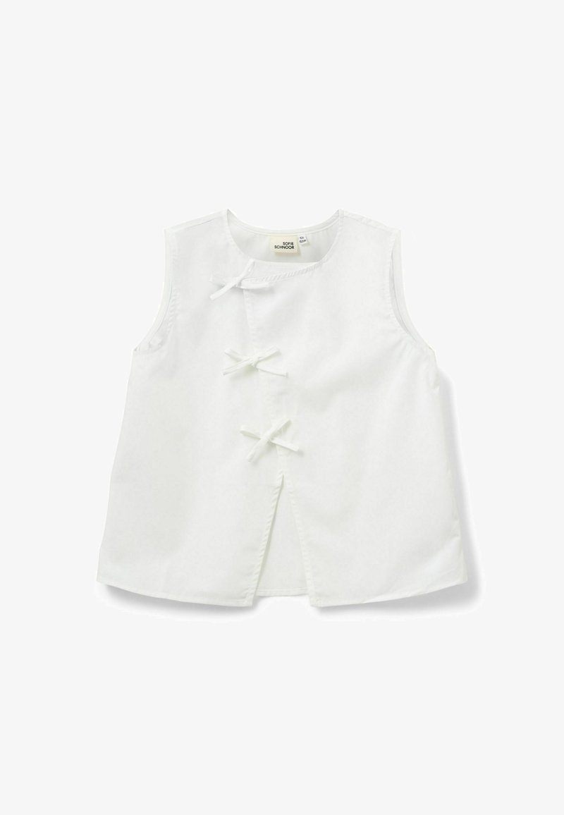Haut blanc sans manches avec trois liens en tissu à l'avant et un col rond, posé à plat sur un fond blanc.