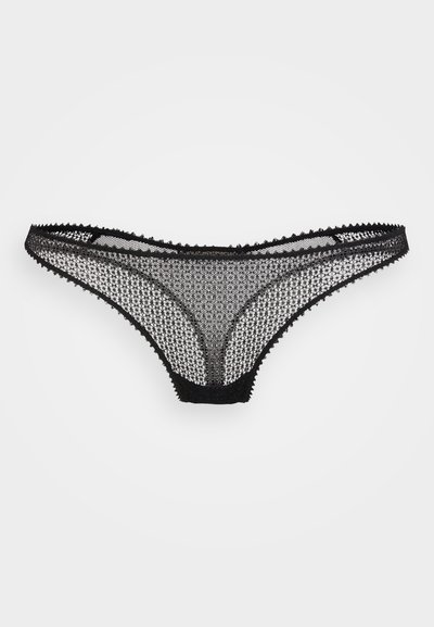 Melnas lencītes, kas izgatavotas no sarežģītas mežģīnes ar ģeometrisku rakstu, ar viļņotām malām un minimālu elastīgu jostu.