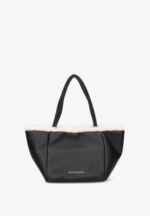 Zwarte gestructureerde tote bag met een zachte crèmekleurige nepbont bovenkant, voorzien van twee stevige hengsels en gouden letters aan de voorkant.