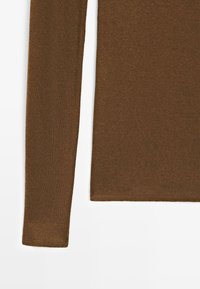 Brown ribbed long-sleeve top with a fitted cut, featuring a soft texture and a straight hemline. No visible patterns or accents.