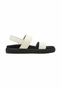 White leather sandals with two wide straps, black rubber sole, and a back strap for support. Flat, minimalistic design with stitching details.