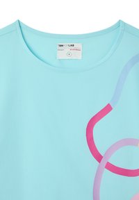 T-shirt azzurro chiaro con scollatura rotonda, caratterizzato da design astratti in curve rosa e viola. Realizzato in tessuto morbido e liscio. Etichetta: TRNPOPLAB, designer Iris D'Ulisse, taglia S.