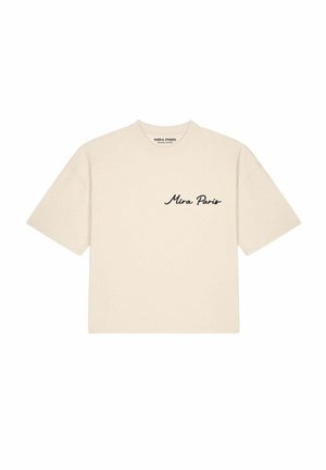 T-shirt beige à manches courtes avec "Mira Paris" en cursive noire sur la poitrine gauche et un col rond.