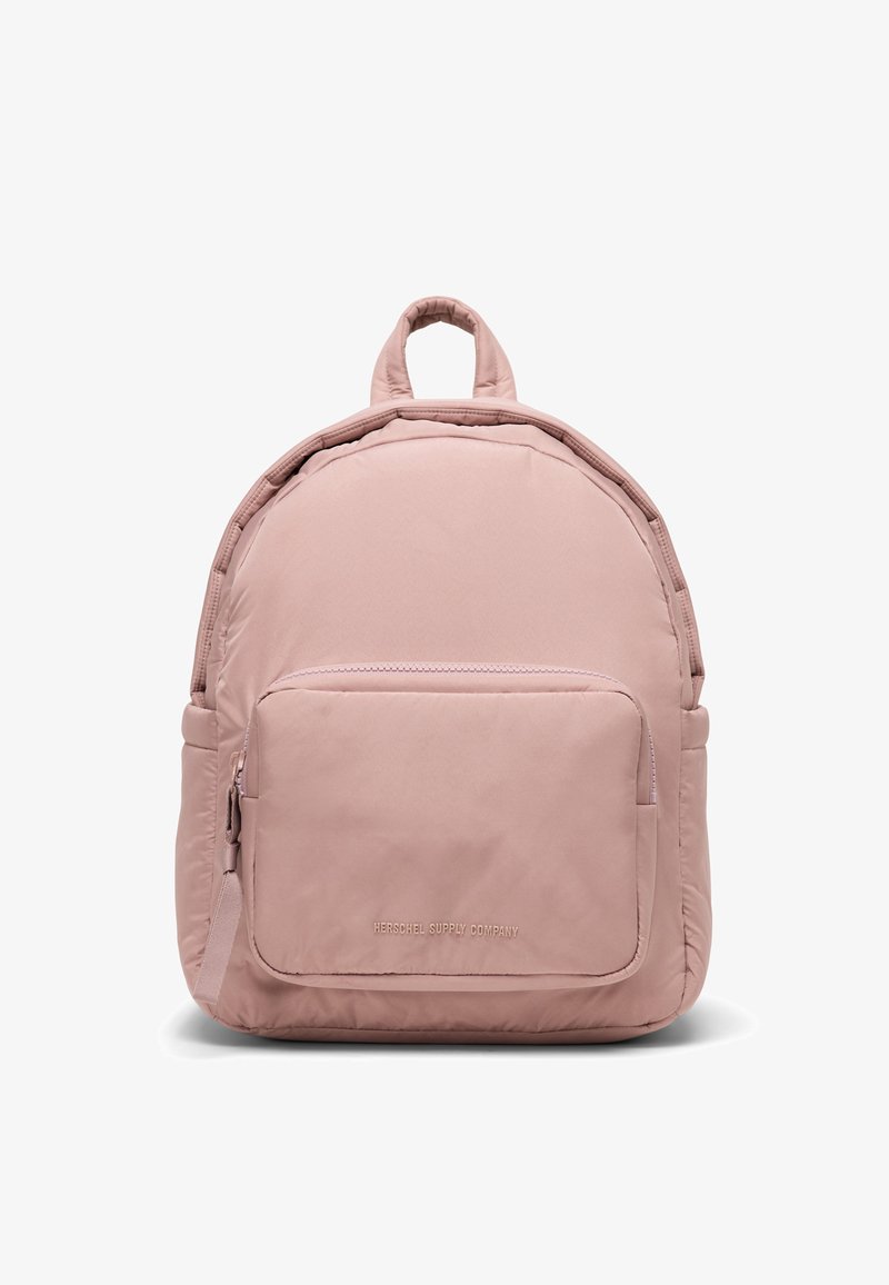 Zaino rosa chiaro con forma arrotondata, realizzato in tessuto resistente. Caratterizzato da una tasca frontale con cerniera e due spallacci regolabili.