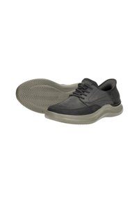 Scarpe in pelle nera con una forma arrotondata, dotate di una suola grigia texturizzata, design con lacci e dettagli cuciti lungo la parte superiore.