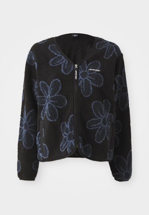 Black fleece jacket with blue floral patterns, zip closure, and two side pockets. Features long sleeves and a rounded neckline.