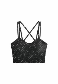 Crop top noir à pois blancs, avec fines bretelles doubles croisées dans le dos, sur fond blanc.