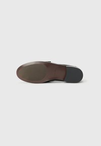 Black leather shoe sole with a smooth finish, featuring a brown rubber heel, rounded toe, and embossed brand logo near the base.