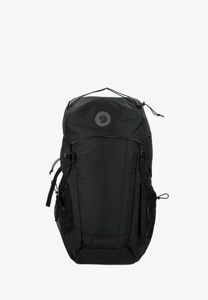 Schwarzer Rucksack mit glatter Stoffstruktur, abgerundetem Oberteil, seitlichen Netzfächern und einem runden Logo auf der Vorderseite. Verfügt über verstellbare Träger.