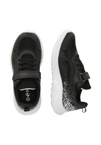 Schwarze Sportschuhe mit einem strukturierten Strickobermaterial, verstellbarem Riemen und einer weißen Gummisohle mit einem Farbverlaufsmuster.