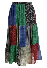 Tilkkutäkkihame, jossa useita geometrisia kuvioita ja värejä, kuten sininen, vihreä, punainen ja musta, sekä röyhelöinen helma. Puuvillasekoitekangas.