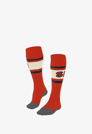 Red knee-high socks with cream and navy stripes, grey textured soles, and a logo on the calf area. Made from a soft, stretchy material.