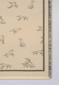 Beige vævet tæppe med sorte silhouettes af greyhounds i forskellige stillinger, omkranset af en sort kant og afsluttet med frynsekant.