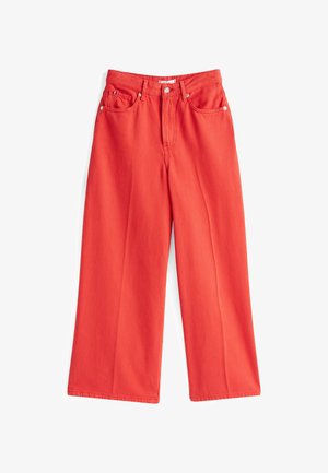 Red wide-leg pants made of cotton, featuring a high waist, front pockets, and a single button closure with a zip fly.
