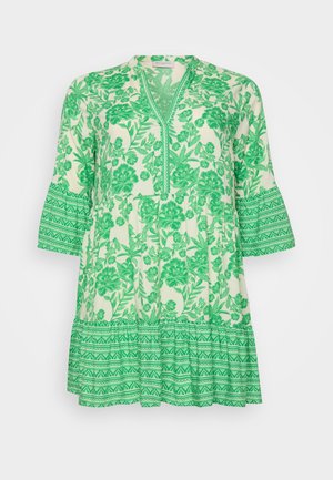 Tunica floreale verde con scollatura a V e maniche a campana. Realizzata in tessuto leggero, presenta motivi intricati di foglie e un orlo a strati con rouches.