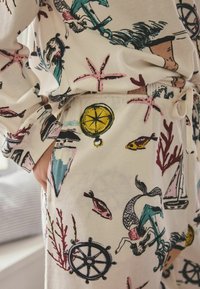 Bavlněné domácí oblečení s mořským motivem obsahujícím kotvy, ryby, mořské panny a kompas v barvách jako tyrkysová, růžová a žlutá.