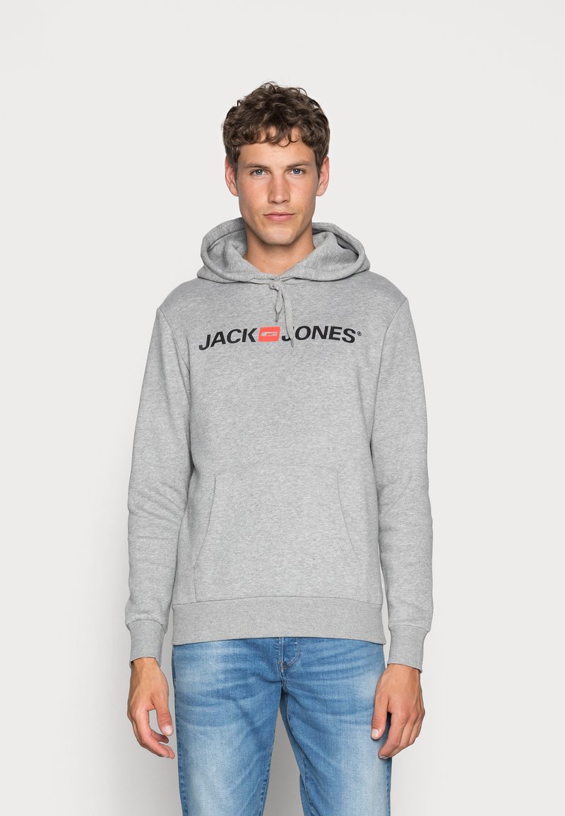Gray cotton hoodie with drawstrings, large front pocket, and "JACK & JONES" logo in black across the chest. Worn over blue jeans.