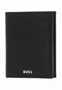 Portefeuille en cuir noir avec une texture granuleuse, design pliable en deux, et logo "BOSS" argenté en bas à l'avant. Compact et élégant.
