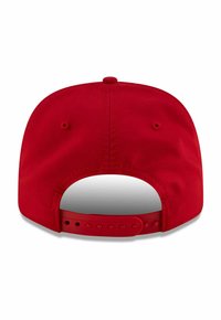 Red baseball cap with a flat brim, smooth texture, and adjustable snap closure. Two ventilation eyelets on the back.