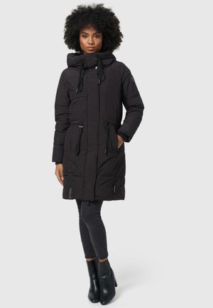 Black puffer coat with a hood, drawstring waist, and long sleeves. Features zippers at pockets and textured quilted design. Paired with black leggings.