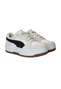 White and beige sneakers with a black suede accent, featuring a white rubber sole and flat laces, designed with perforated details.