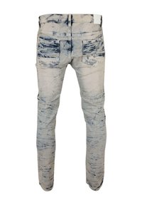 Isprane traperice s plavim tie-dye uzorkom, dizajnirane s stražnjim džepovima i ravnim krojem. Sadrže vidljive detalje šavova.