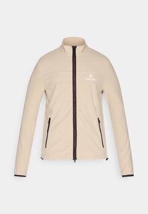 Veste beige à fermeture éclair complète avec une fermeture éclair noire et rouge, deux poches zippées, et le logo "Fire + Ice" sur la poitrine gauche.