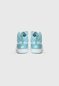 Høye sneakers med lys blå overdel og hvite detaljer, strukturert stoff, polstret krage og fremtredende Nike-logo på hælen.