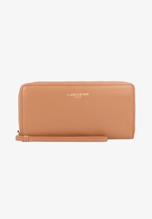 Tan leather wallet with textured finish, gold logo "LANCASTER PARIS" on the front, zip closure, and wrist strap.