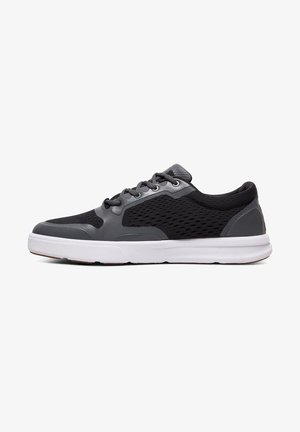 Black and grey athletic shoes with a mesh upper, rubber sole, six eyelets, and a textured toe cap. Side pattern features ventilation holes.