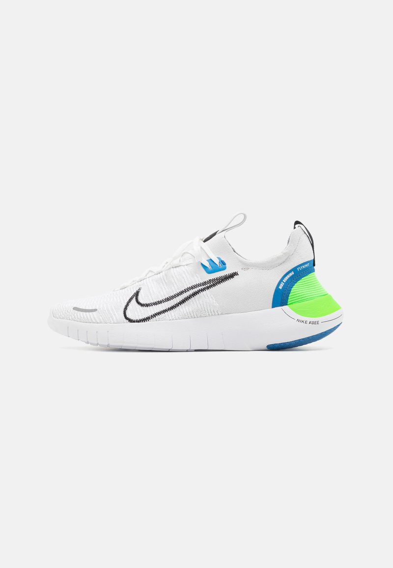 White knit sneaker with a textured design, black swoosh, blue and green accents, and a contoured sole featuring visible grooves.